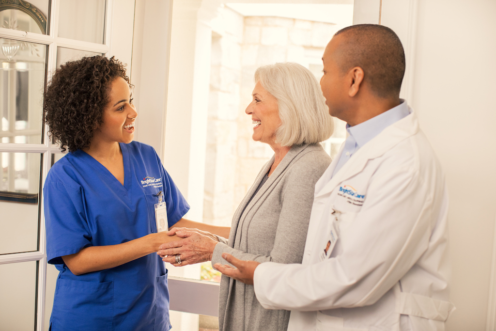 A BrightStar Care franchise's nurse and doctor consult with a client.