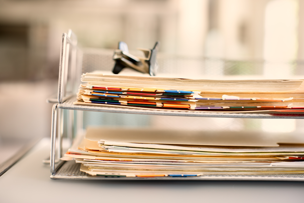 A desk organizer filled with files can helps BrightStar Care franchisees prioritize data.