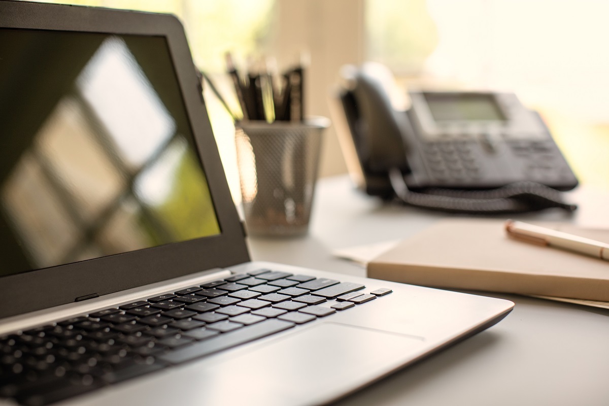 A laptop sits on a desk, a great tool for BrightStar Care Franchisees