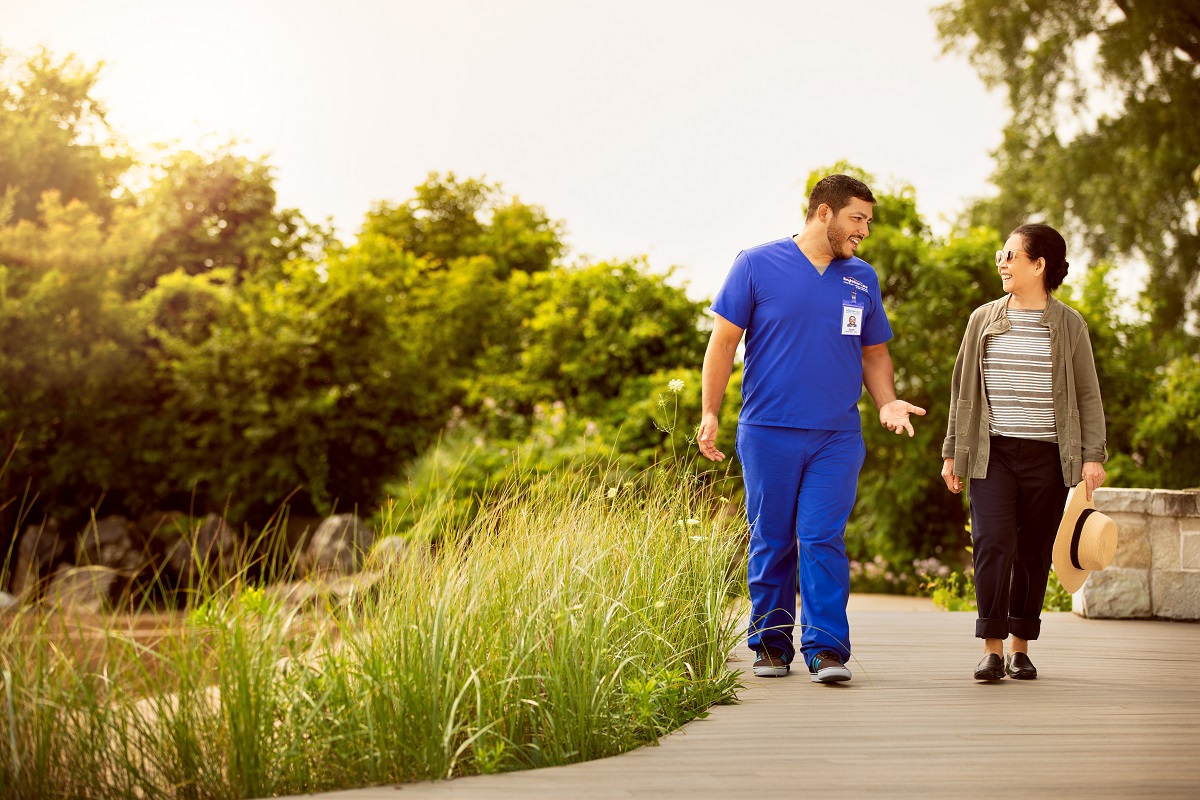 nurse with patient walking