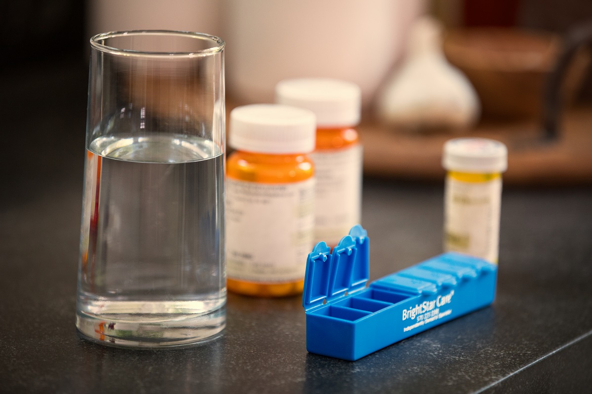 glass of water and prescription bottles