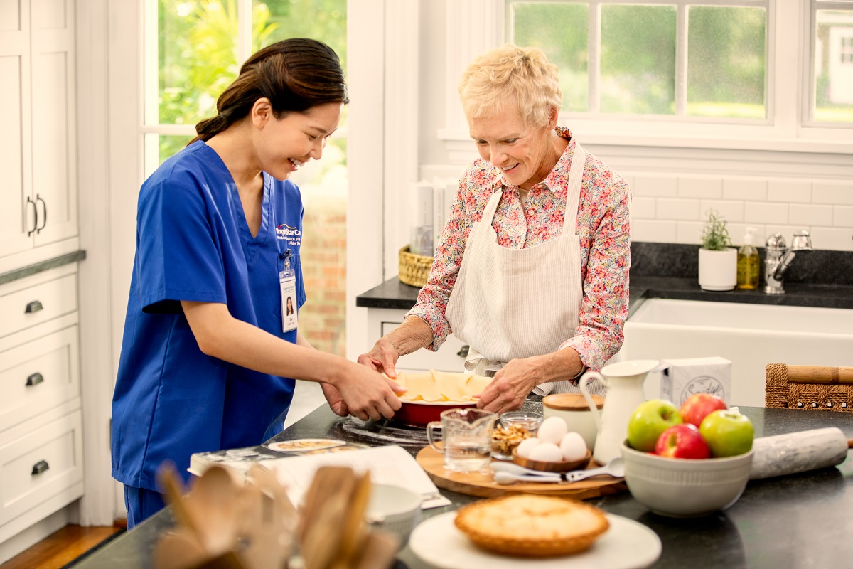 nurse helping patient in kitchen