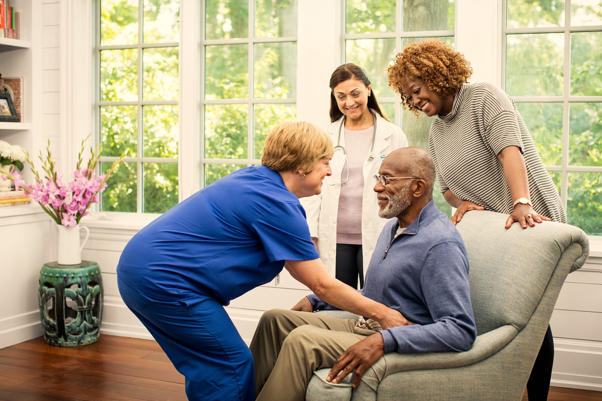 nurse helping elderly man