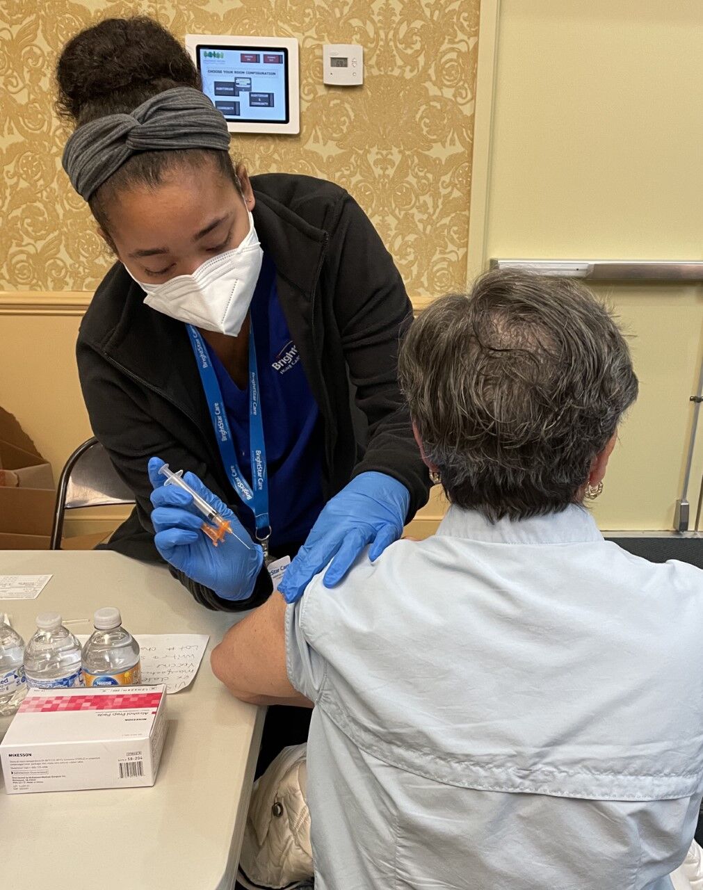 nurse injecting a patient