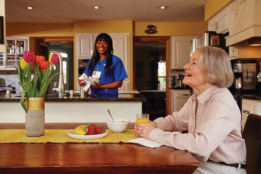 nurse with patient in home